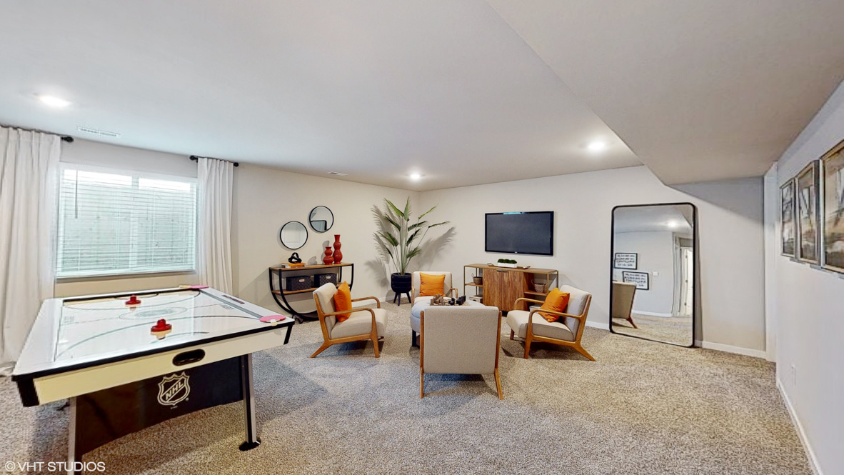 Finished basement living area with comfortable seating space and flexible room for entertaining or relaxing.