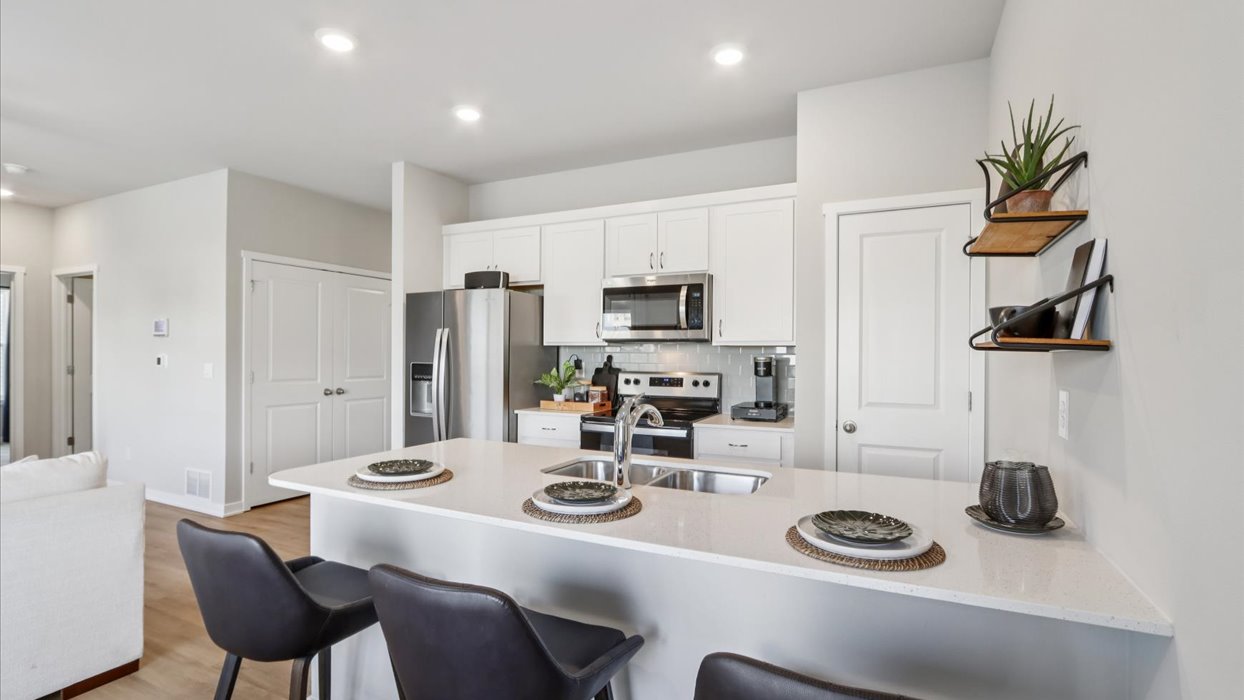 Kitchen with white cabinetry and quartz countertop