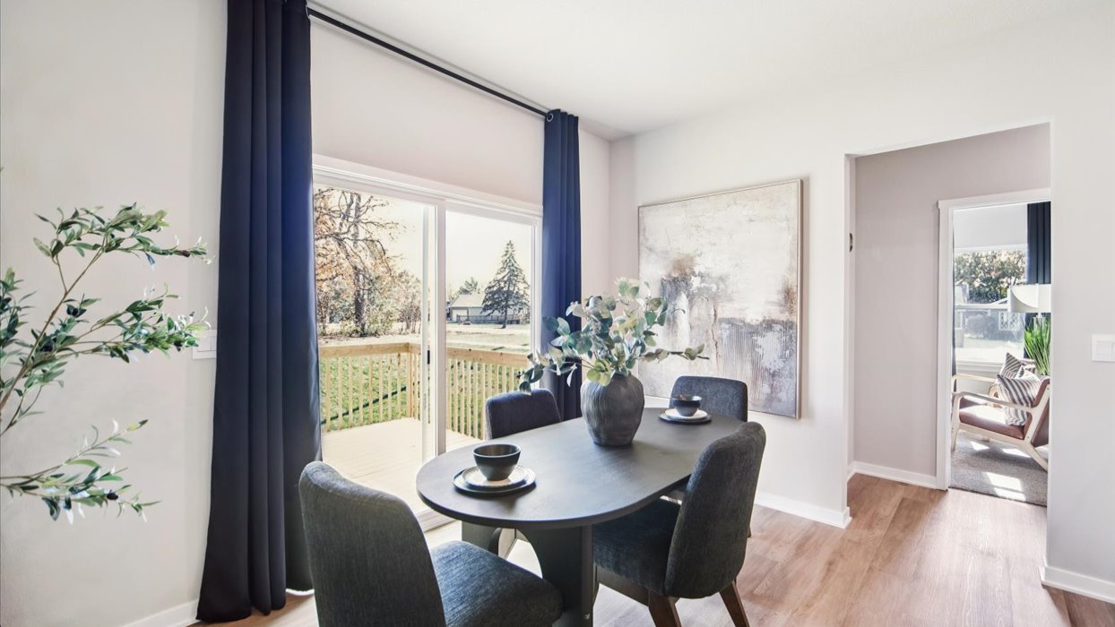 open concept dining area with black table and chairs
