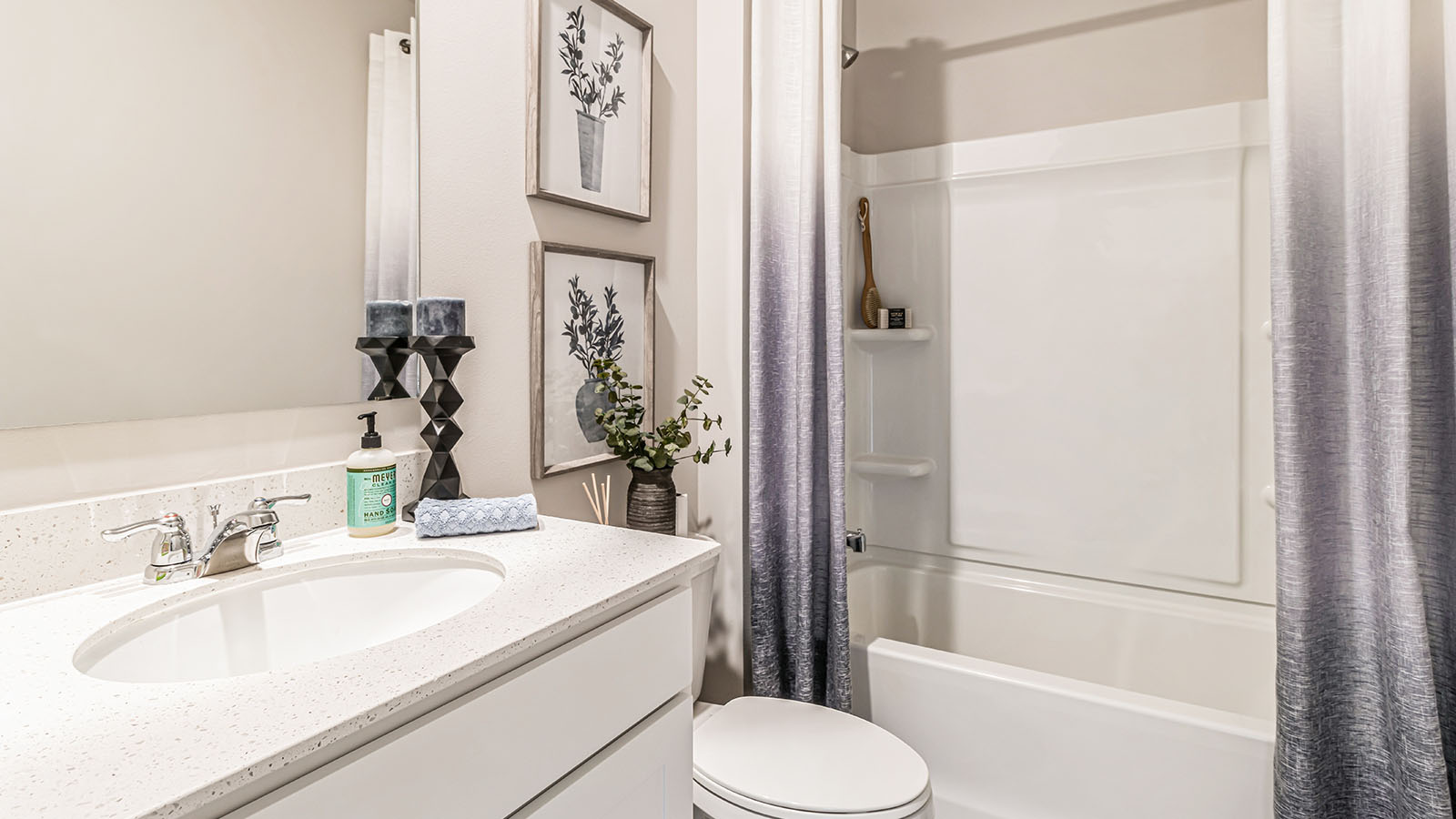 Stylish full bathroom with bright lighting and functional design.