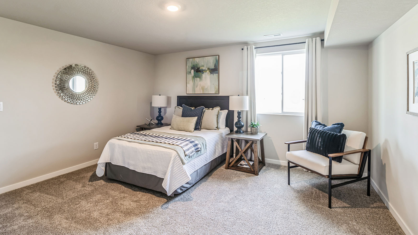 Private lower-level bedroom with natural light and functional storage space.