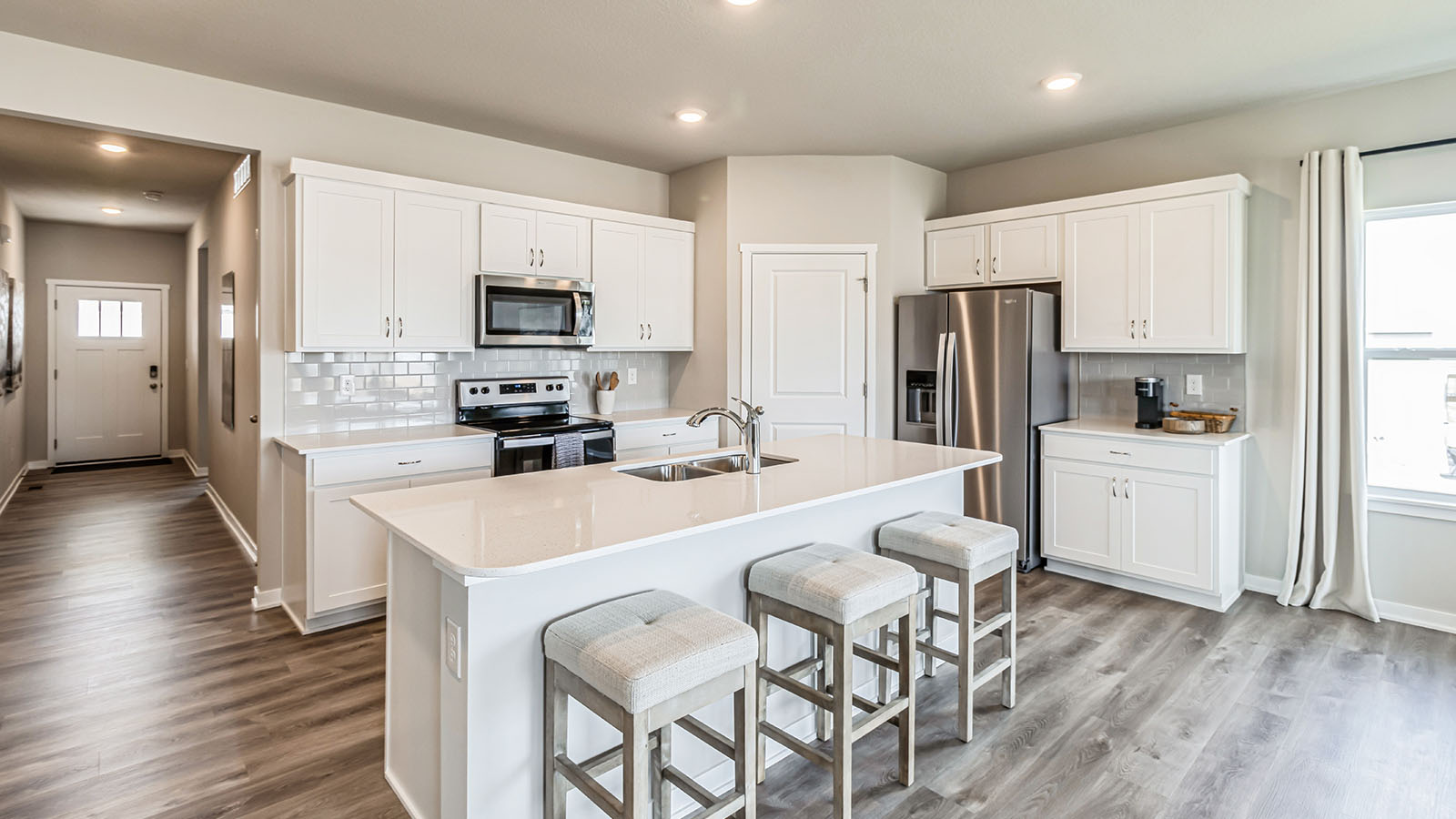 Kitchen with white cabinetry and quartz countertop