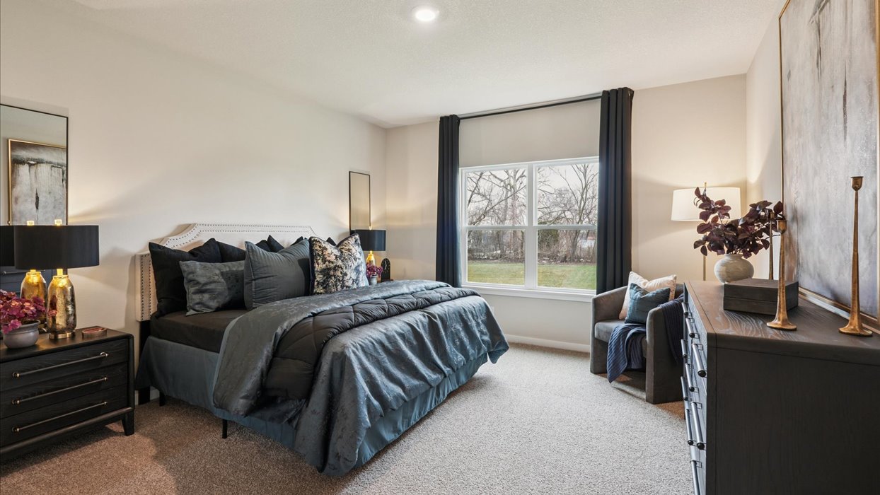 primary bedroom with large window that floods the room with natural light