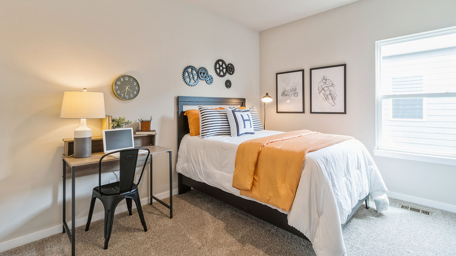 first bedroom with small window and twin bed with desk