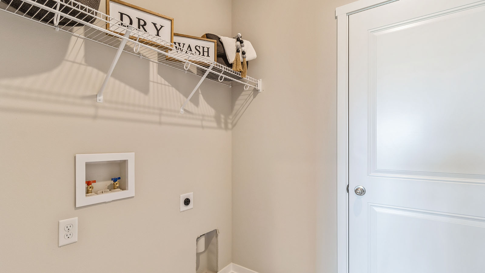 laundry room with white wire shelving