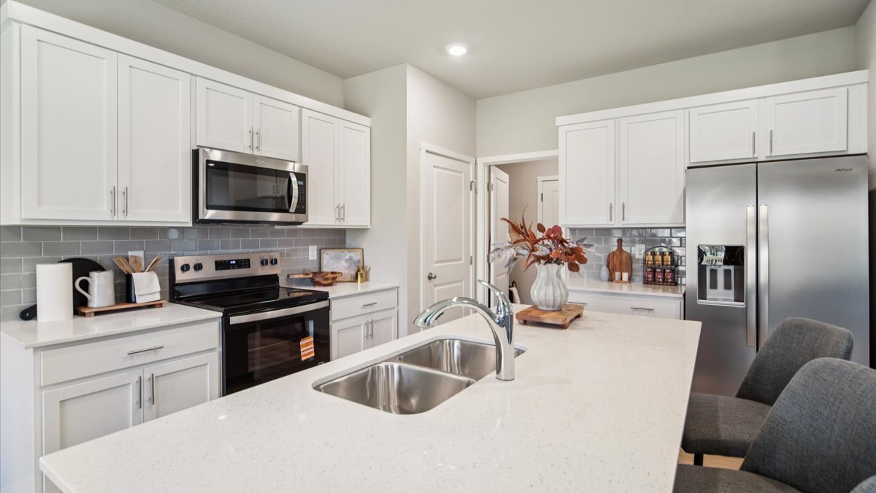 Kitchen island view looking toward the dining area emphasizing serving flow and open design.