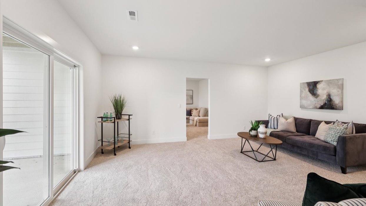 Finished basement living area with comfortable seating space and flexible room for entertaining or relaxing.