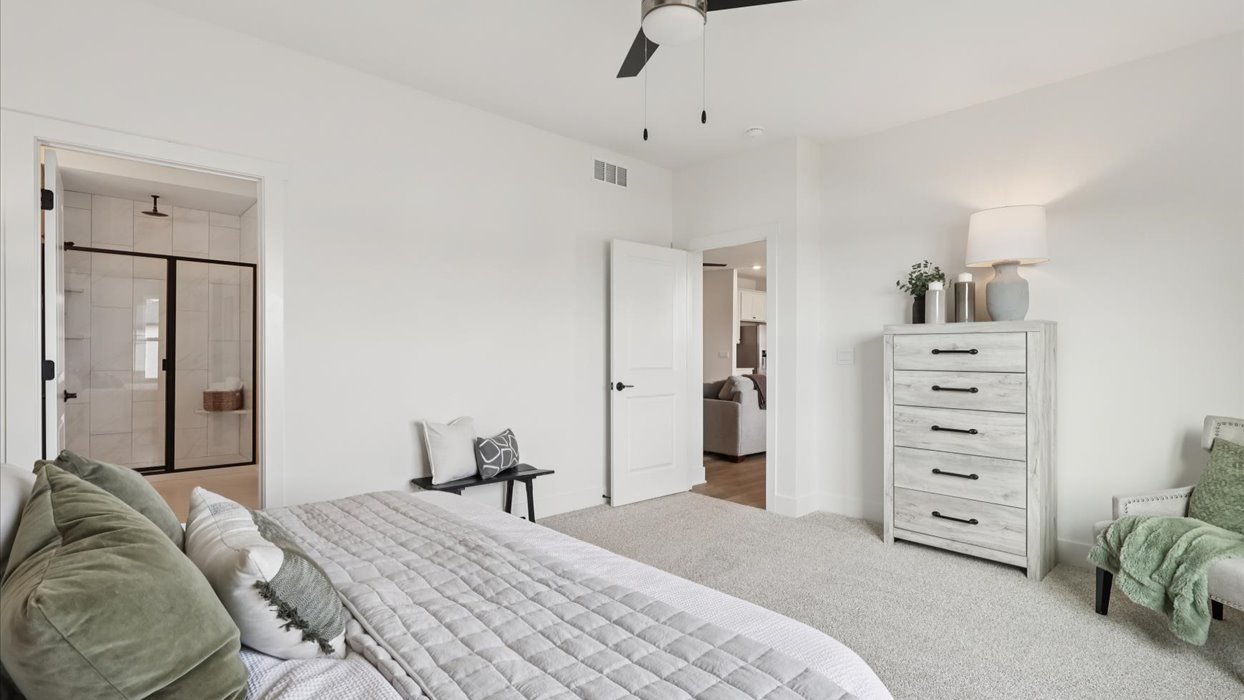 primary bedroom with bench and dresser