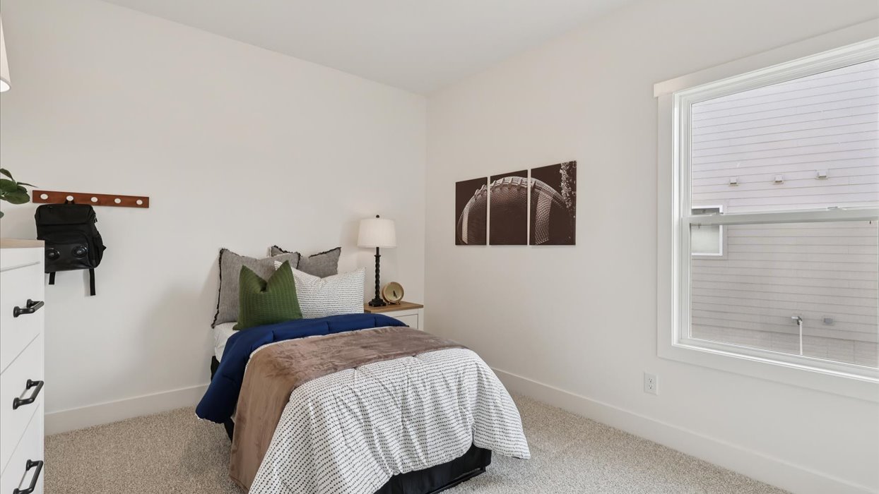 third bedroom with twin bed and small window