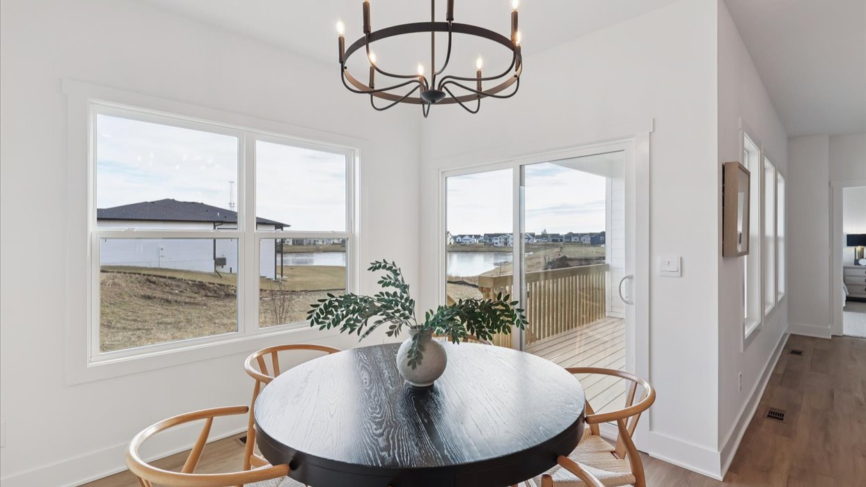 black dining room table next to window and sliding glass doros