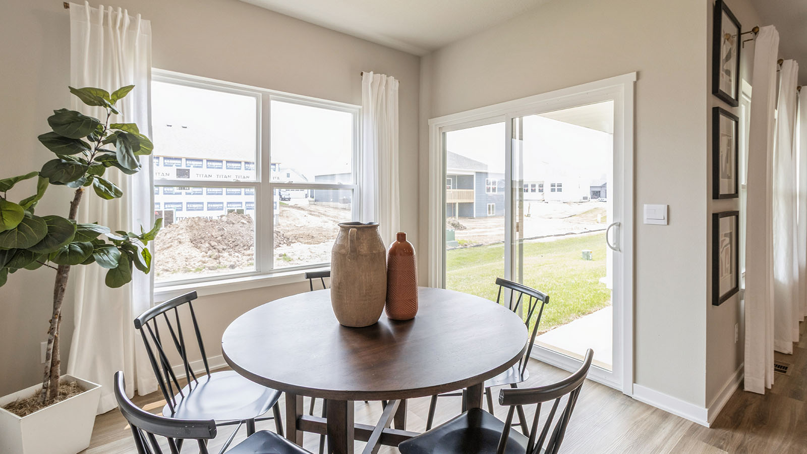 dining room table with chairs next to sliding glass doors