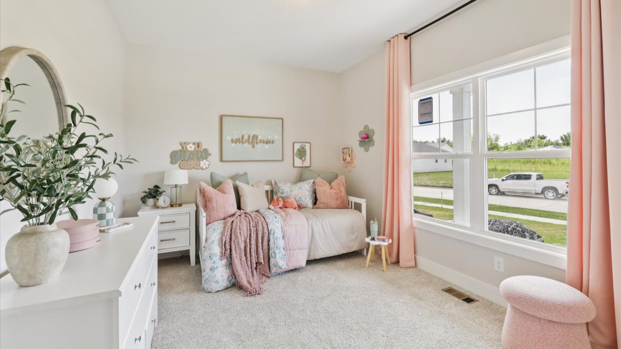 first bedroom with large window and twin bed
