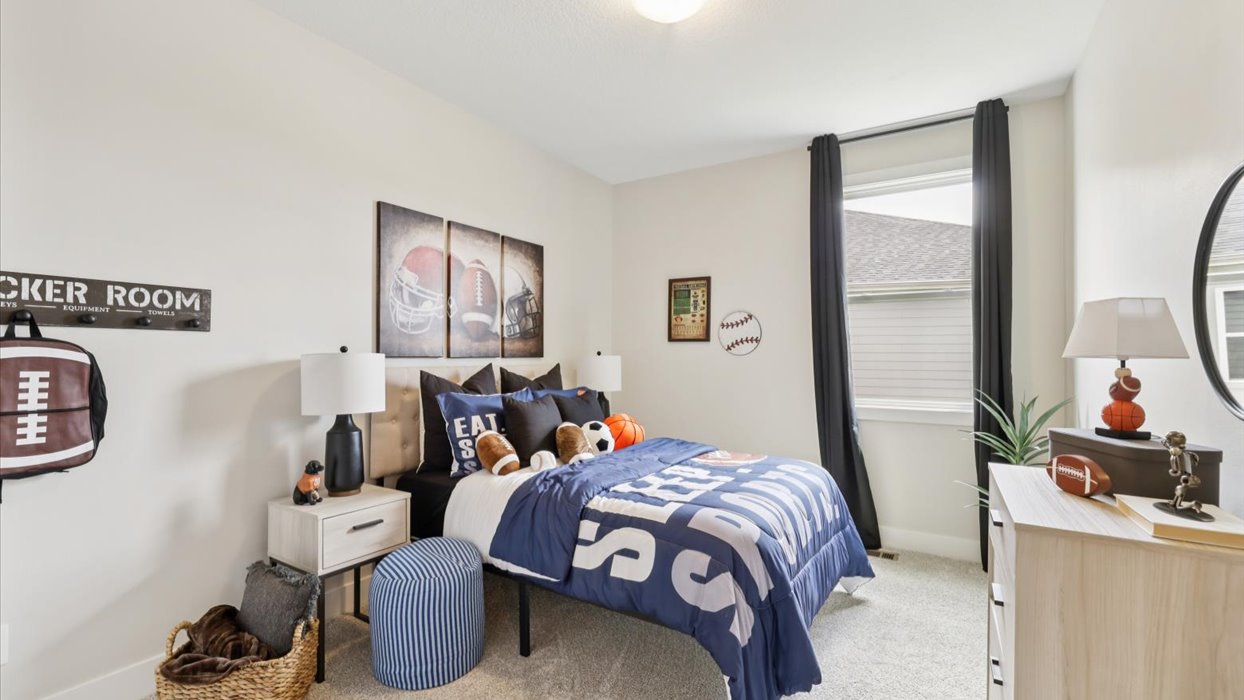 second bedroom with small window and queen bed