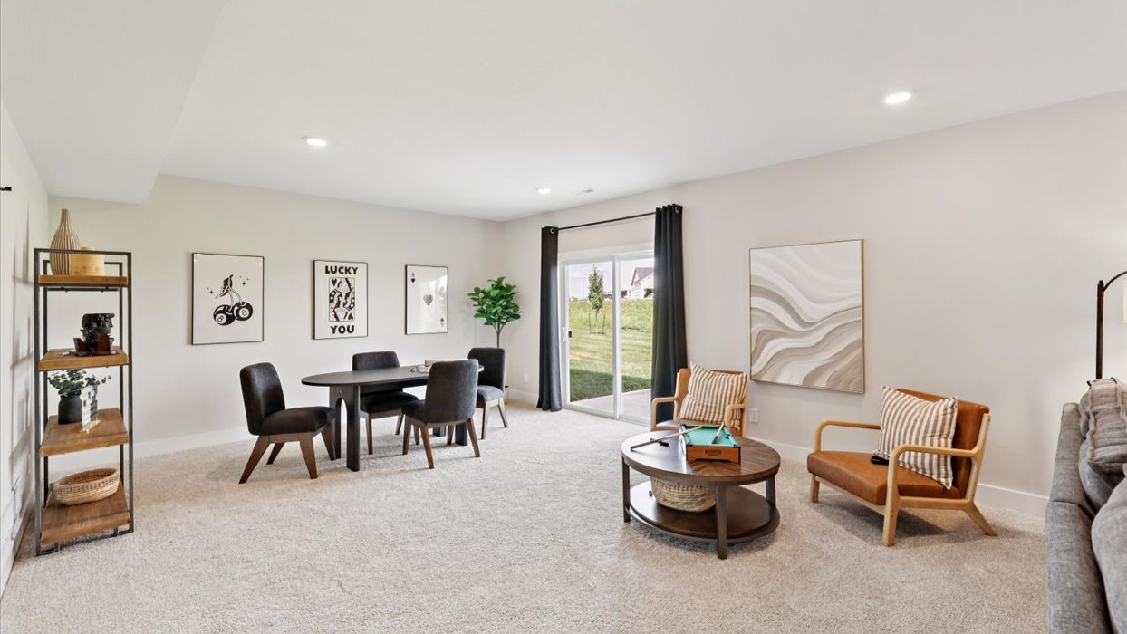 finished basement with lots of seating and window