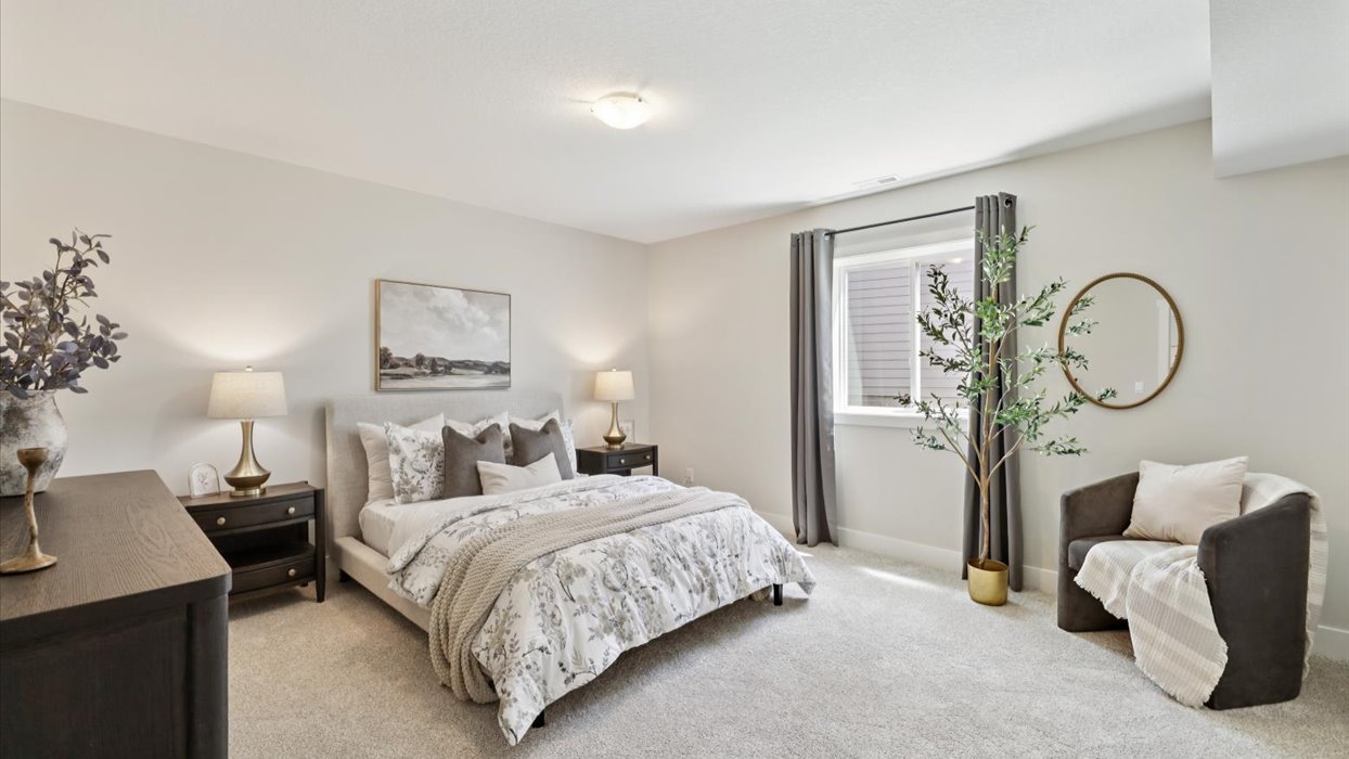third bedroom in basement with bed and window