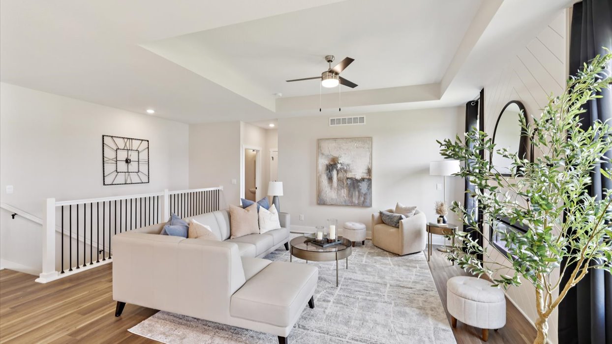 living room with white couches and rug