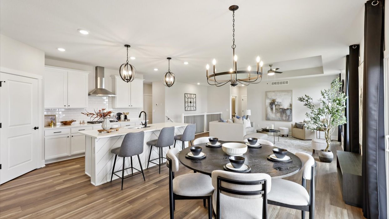 dining area with black table and white chairs
