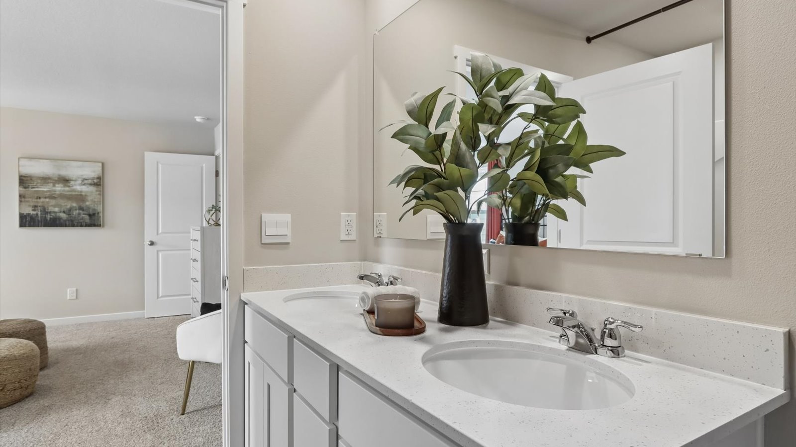 Spacious primary bathroom featuring dual vanities, modern fixtures, and a walk-in shower.