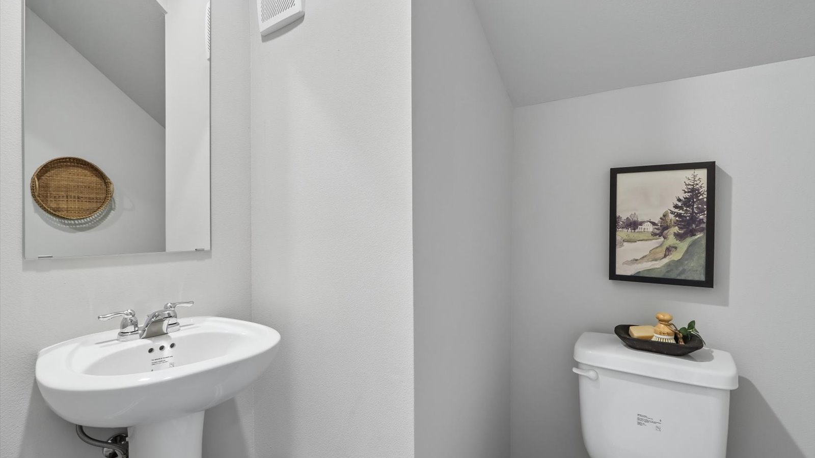 Convenient main-level powder room with updated fixtures and bright lighting.