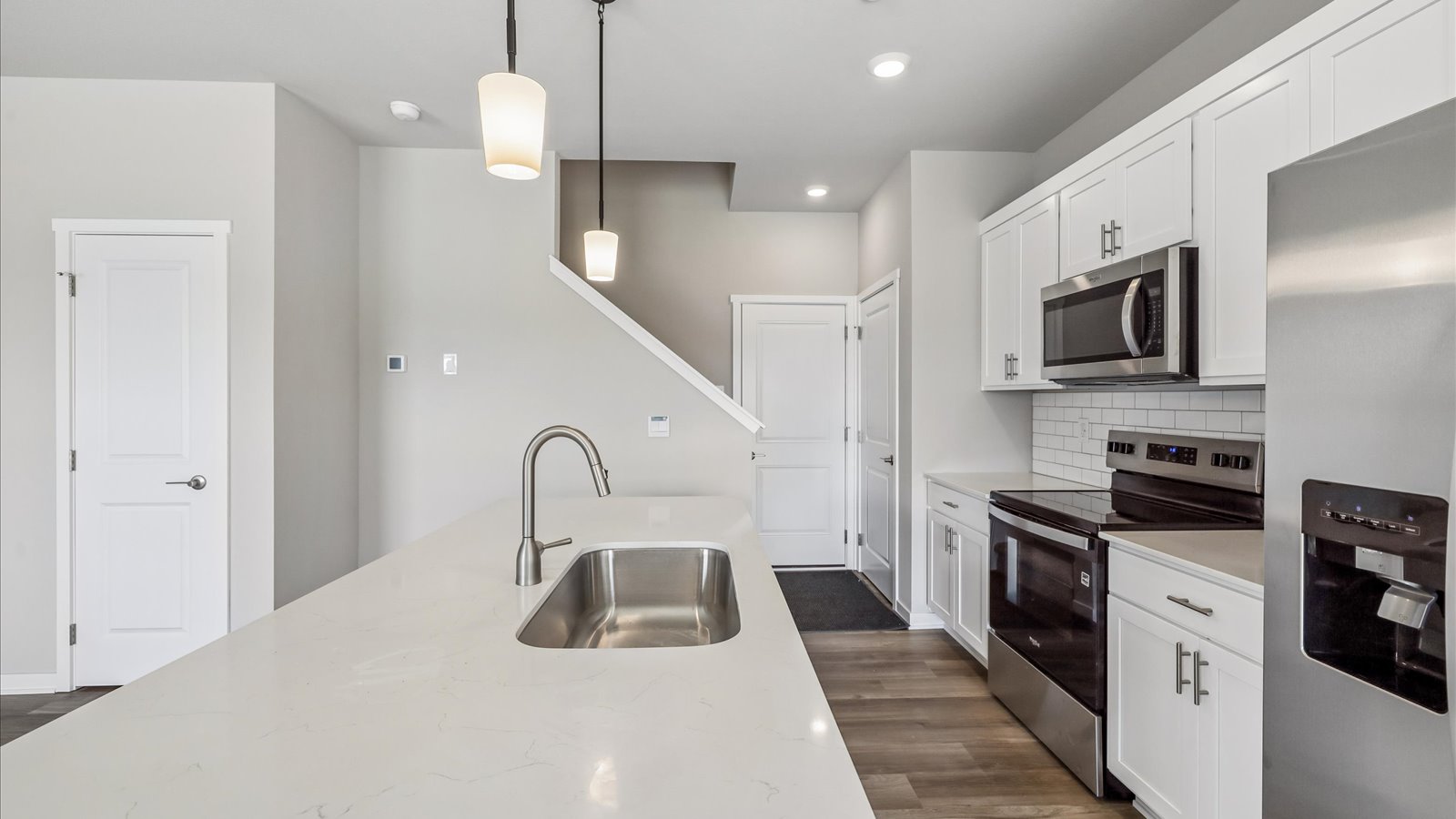 Kitchen with white cabinetry and quartz countertop