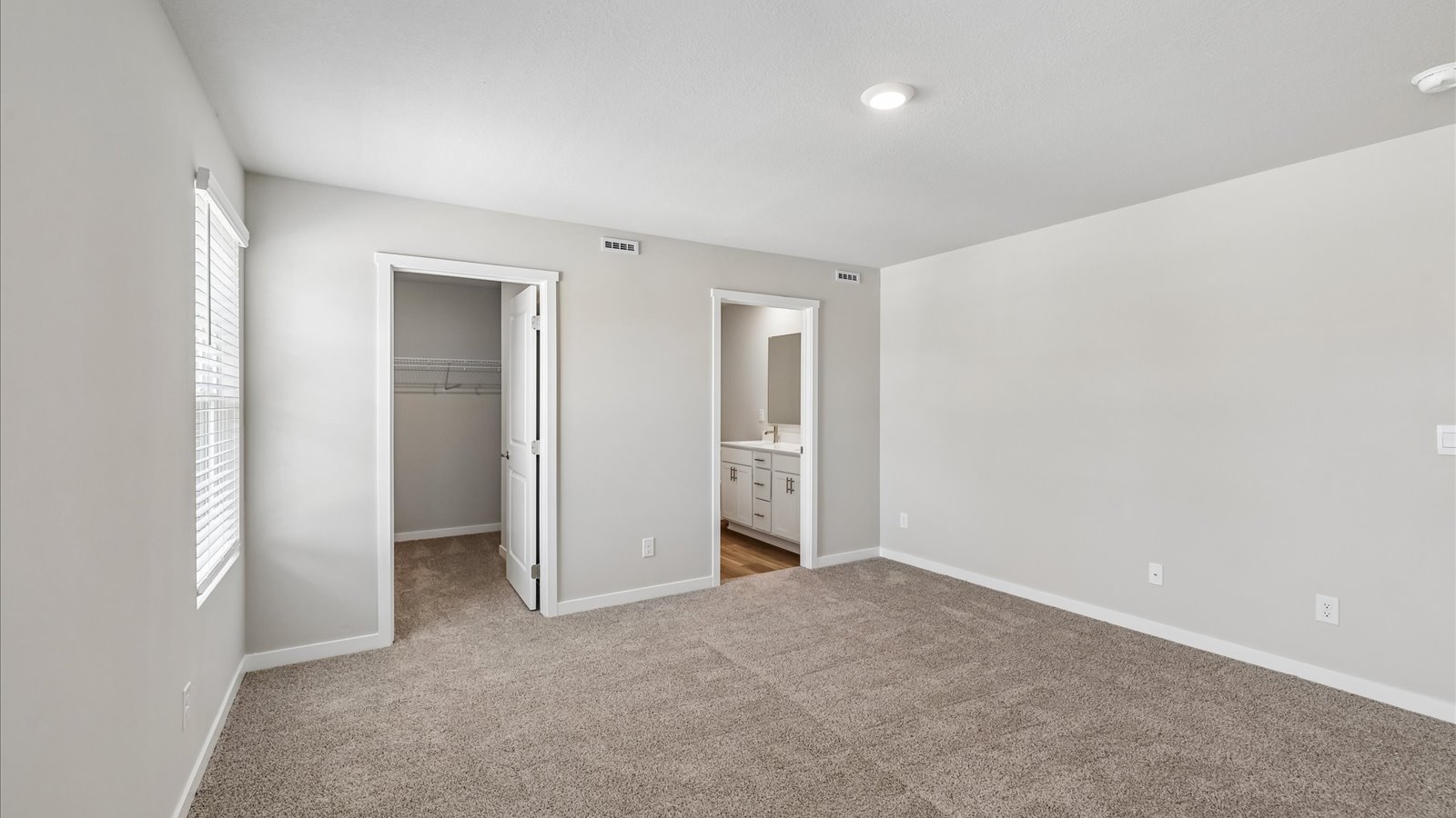 Primary bedroom with natural lighting and spacious layout