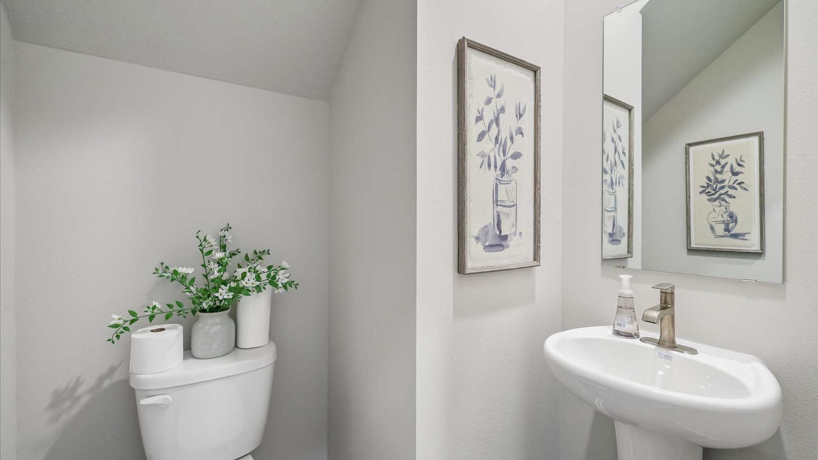 Convenient main-level powder room with updated fixtures and bright lighting.