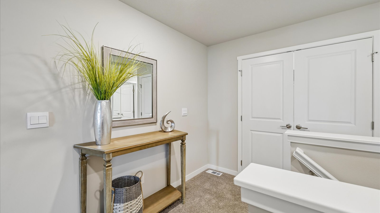 Open landing at the top of the stairs with room for a table and decorative accents.