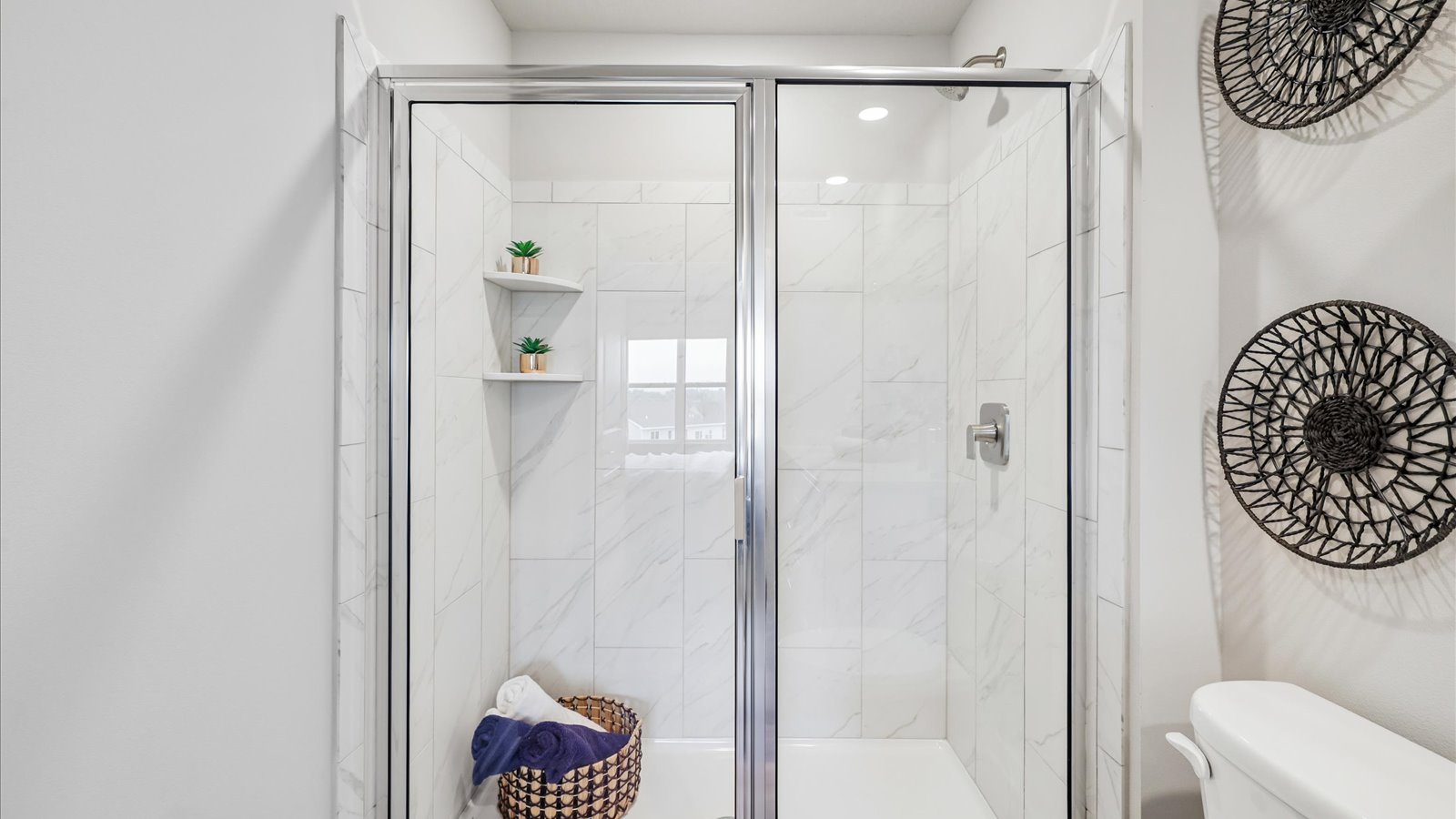 Spacious primary bathroom featuring dual vanities, modern fixtures, and a walk-in shower.