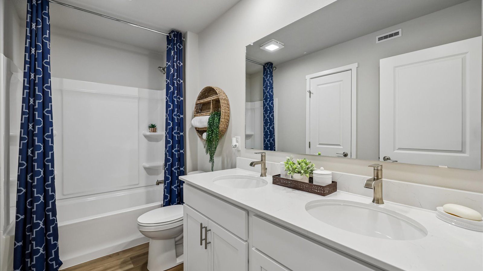 Stylish full bathroom with bright lighting and functional design.