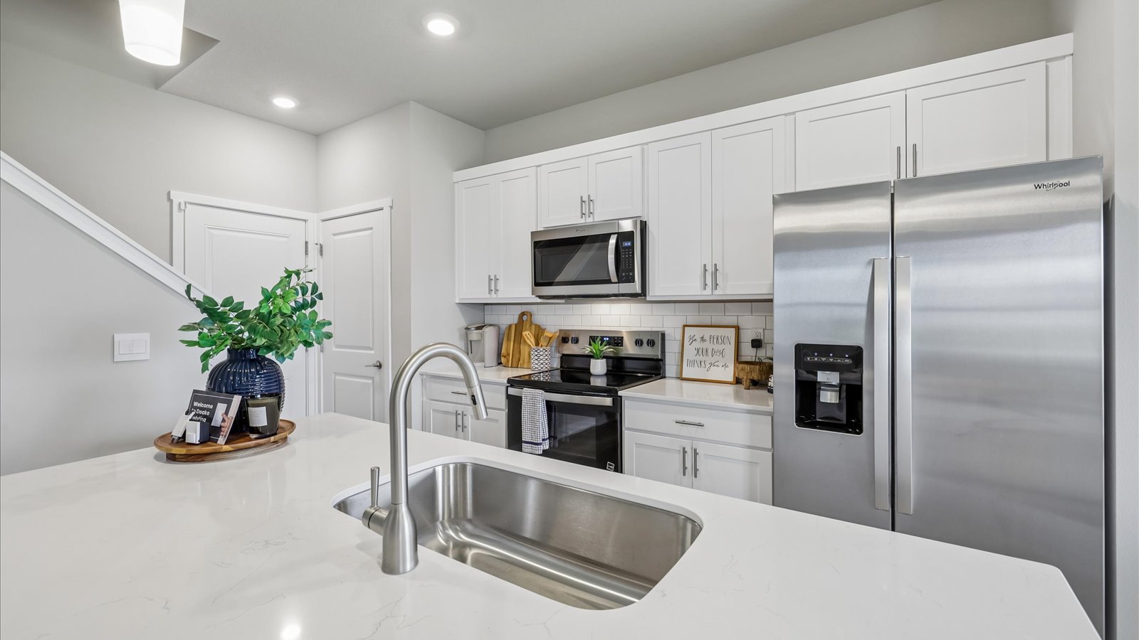 Kitchen with white cabinetry and quartz countertop