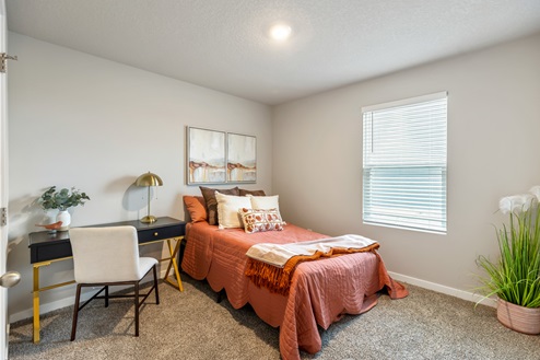 Bedroom with window and bed with desk