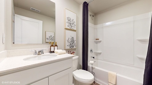 Bathroom with white cabinets and bathtub