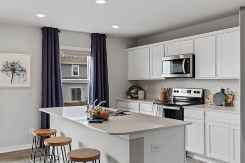 Kitchen with white cabinets and stainless-steel appliances
