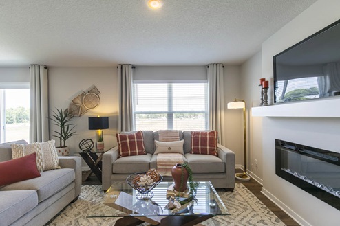 living room with mounted tv and electric fireplace