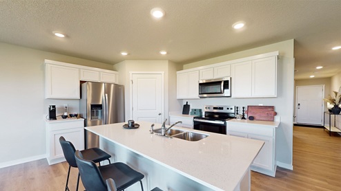 Kitchen with white cabinetry and island
