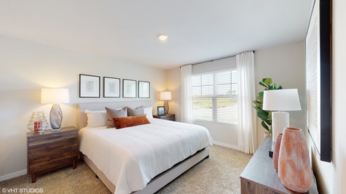 primary bedroom with king size bed and window