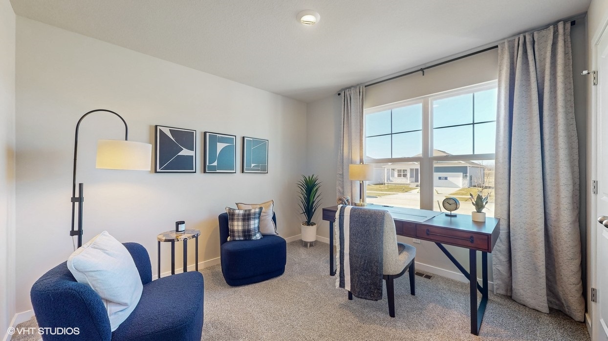 Bedroom with carpeted floors and a large window.