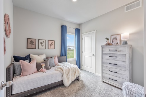 Second bedroom with bed and white dresser