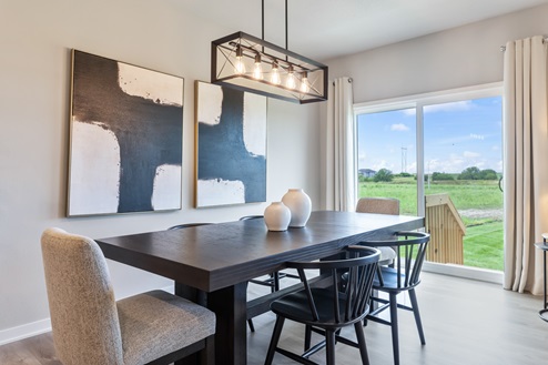 Black dining room table next to sliding glass doors