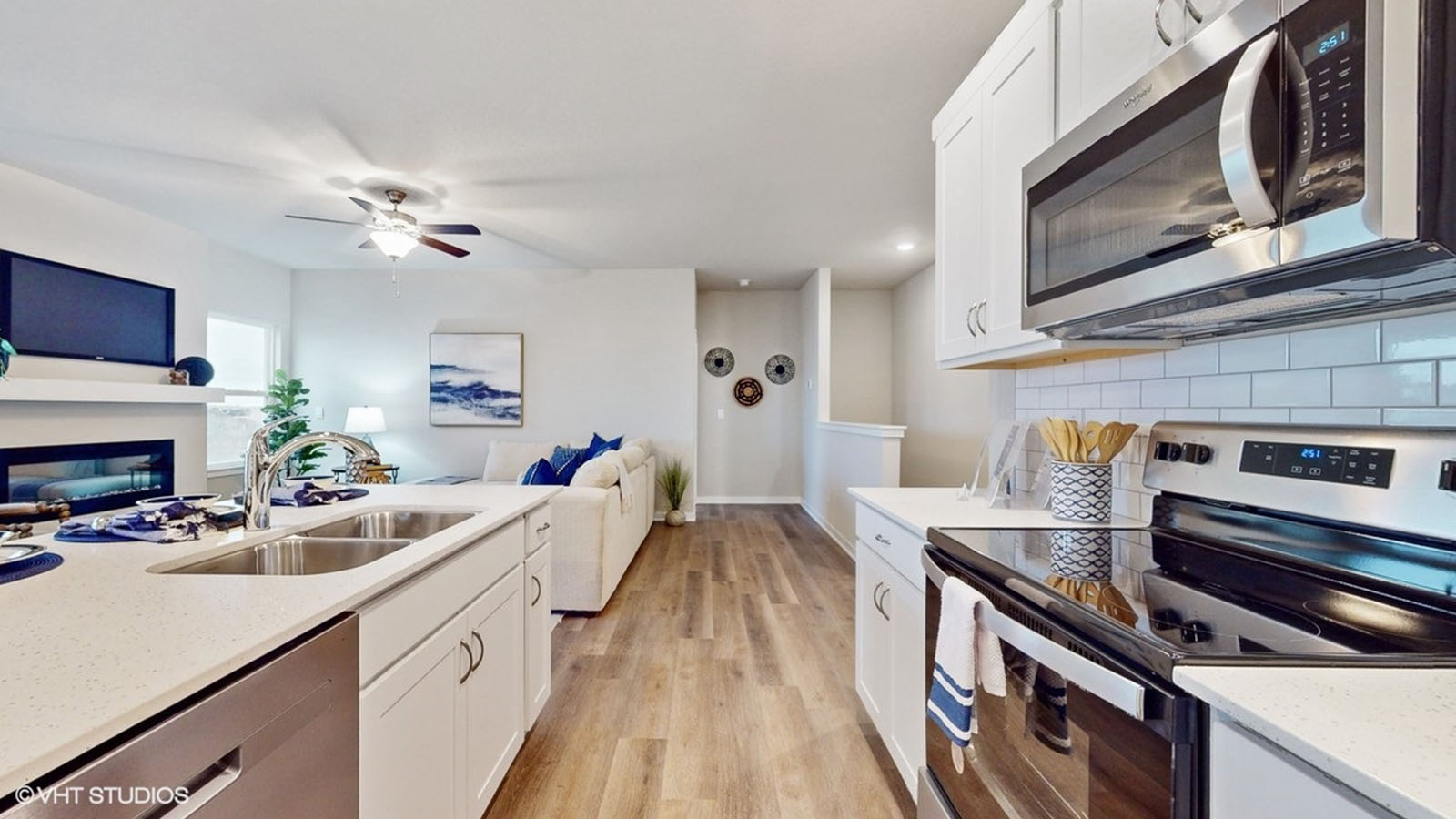 Kitchen with stainless-steel appliances overlooking living room