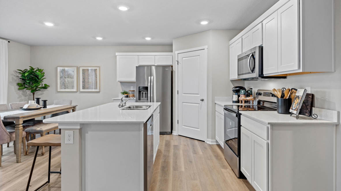 Kitchen with white island and stainless-steel appliances