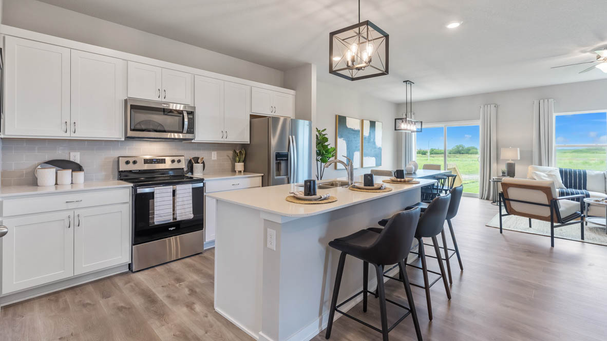 Kitchen with white cabinets and unique light fixture