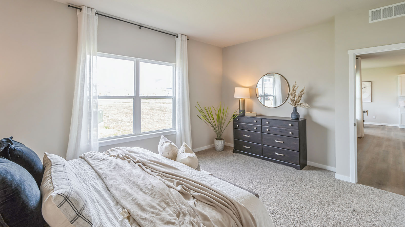 Primary bedroom with bed and dresser