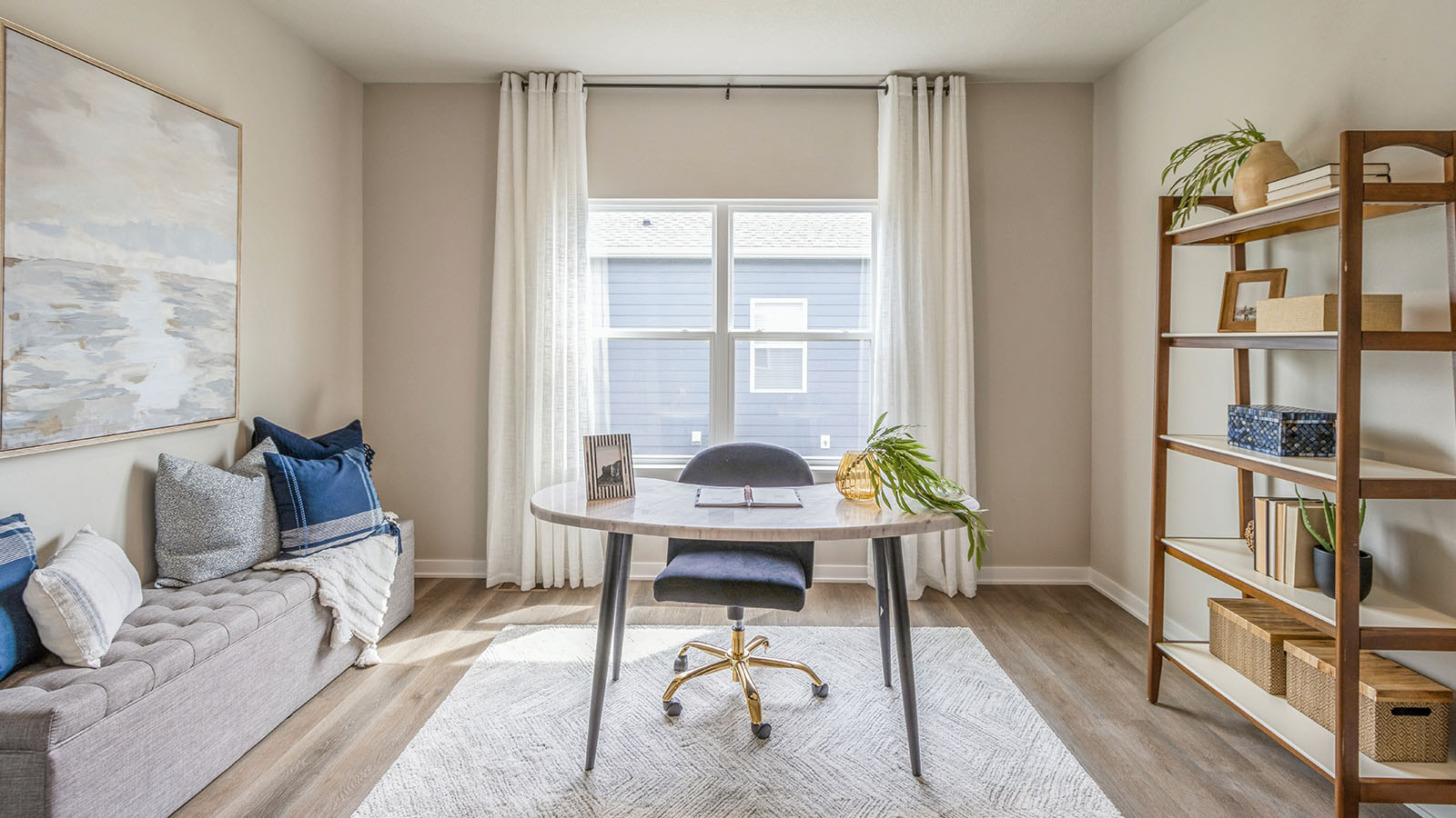 Office with desk and couch with shelves