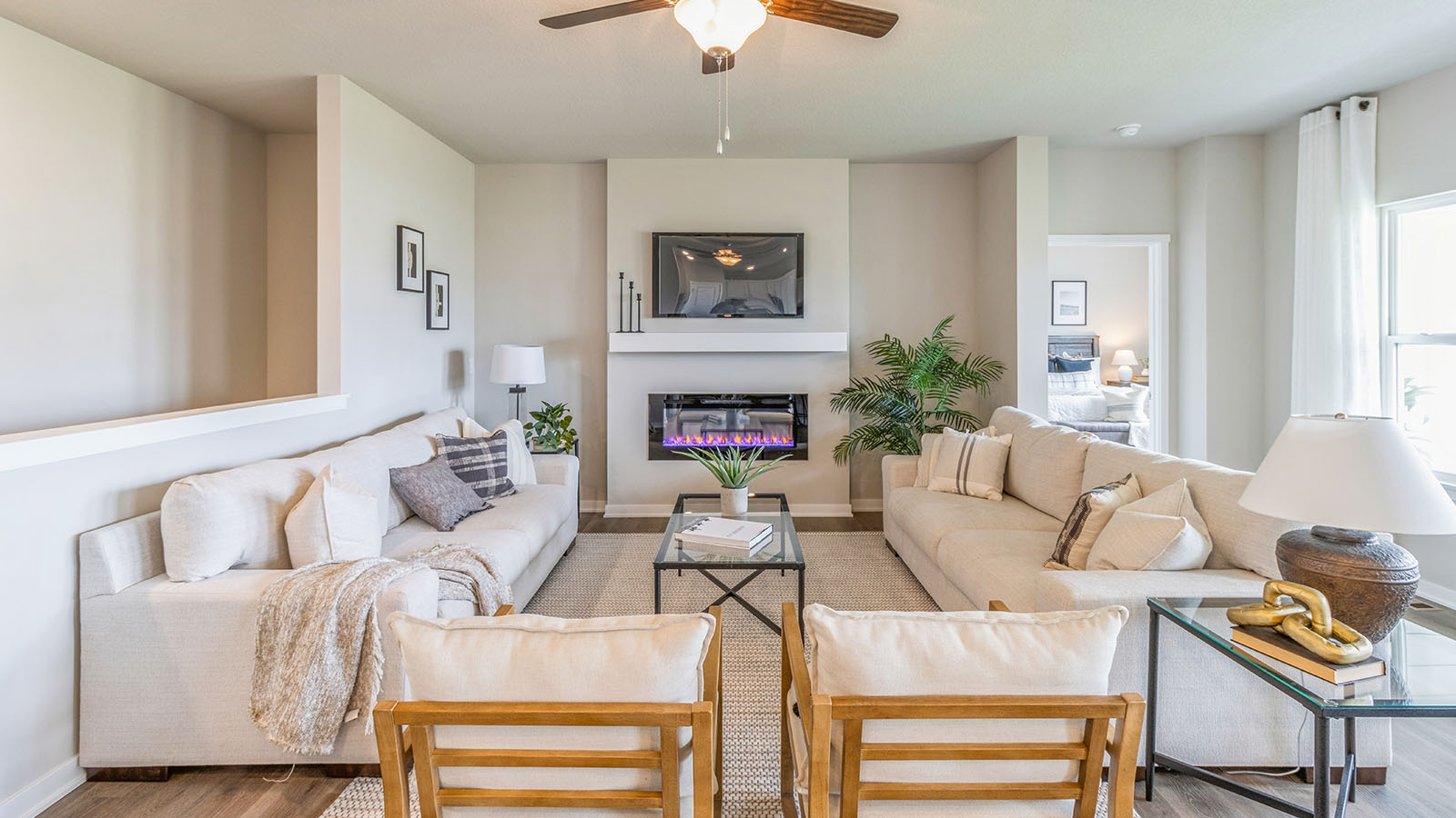 Living room with mounted tv and overhead fan