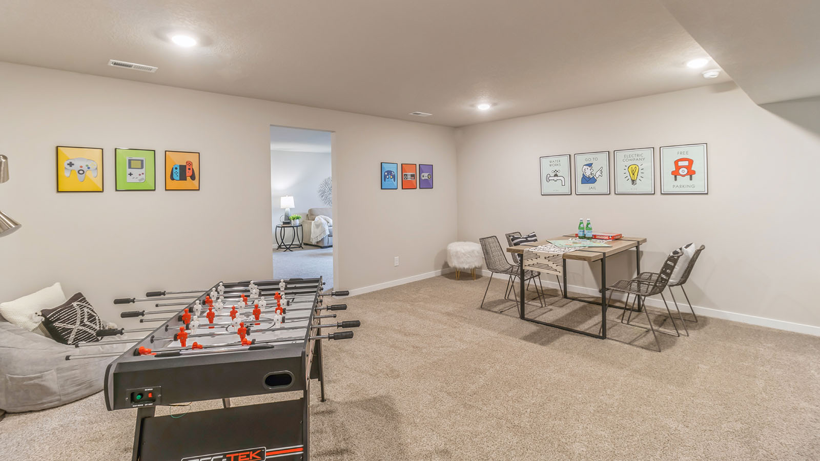 Family room in basement with foosball table and seating