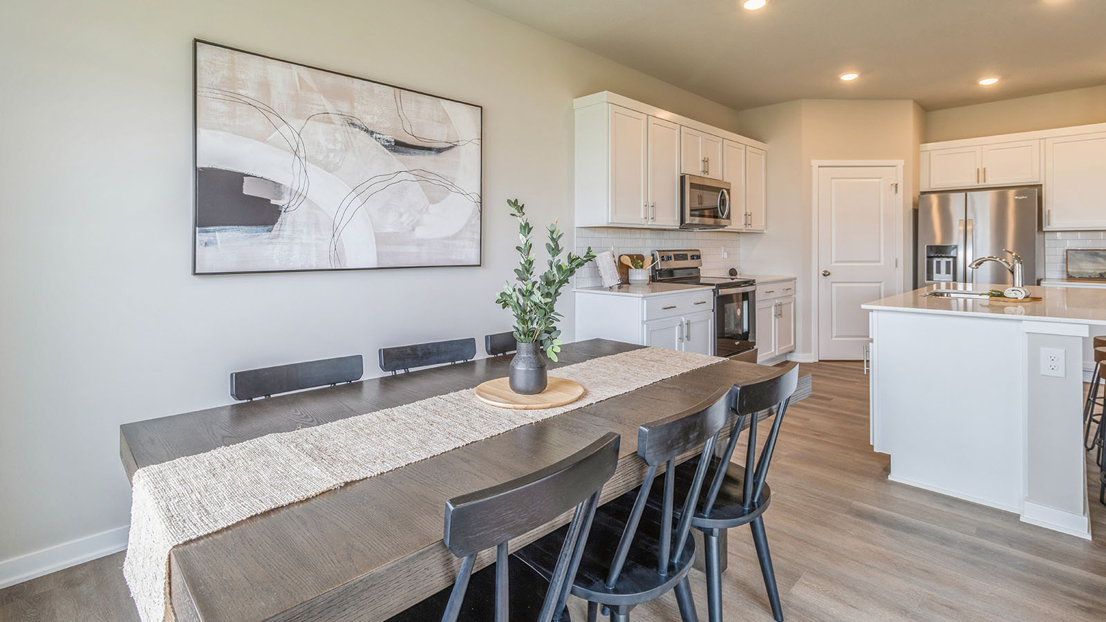 Dining area with wood table next to open kitchen