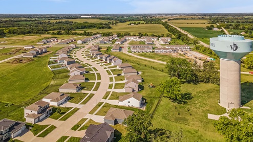 Aerial view of Single Family homes and townhomes with water tower in Fox Ridge community