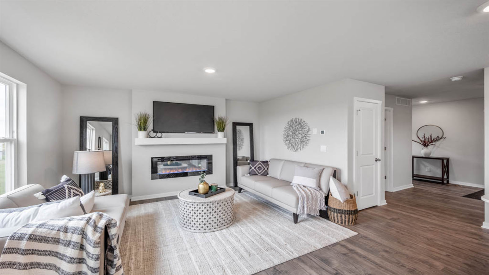 Bright living room with large area rug and couches