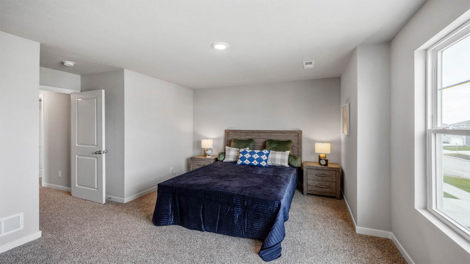 Bright first bedroom with window and natural lighting